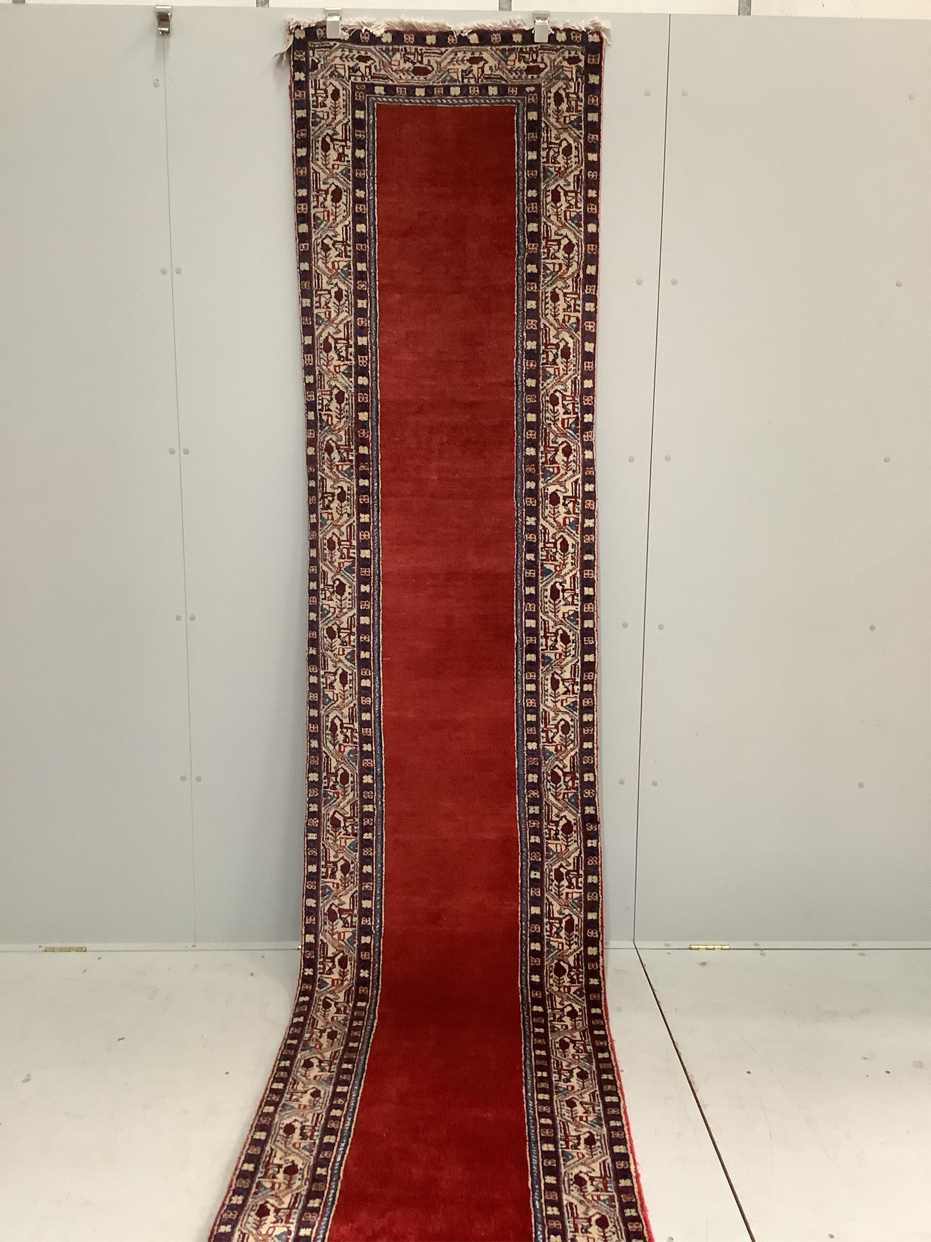 An Araak red ground runner, 440 x 76cm. Condition - fair to good